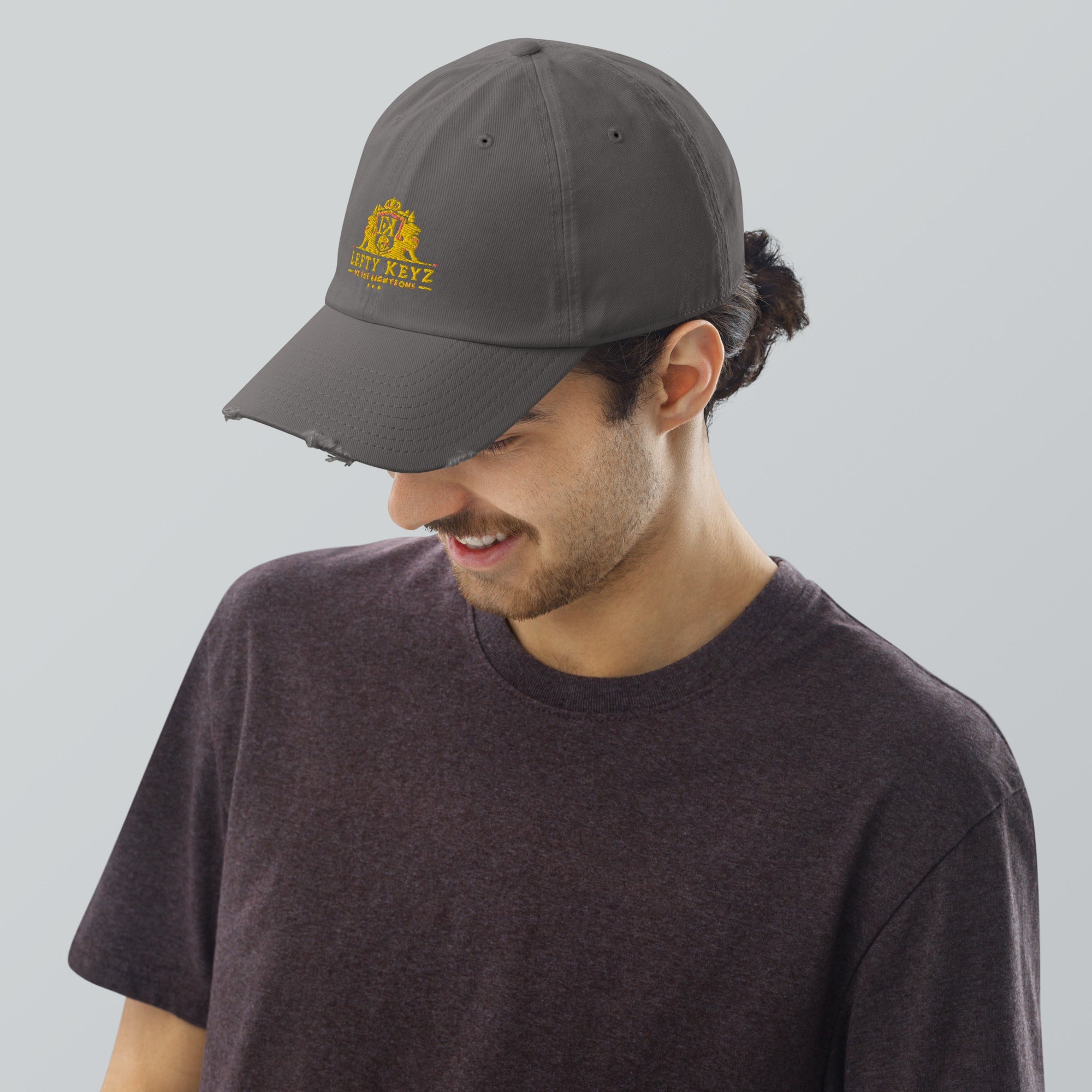 Leftykeyz Distressed Dad Hat: Gray cotton twill cap with vintage look and artistic logo. Stylish & comfortable casual wear.