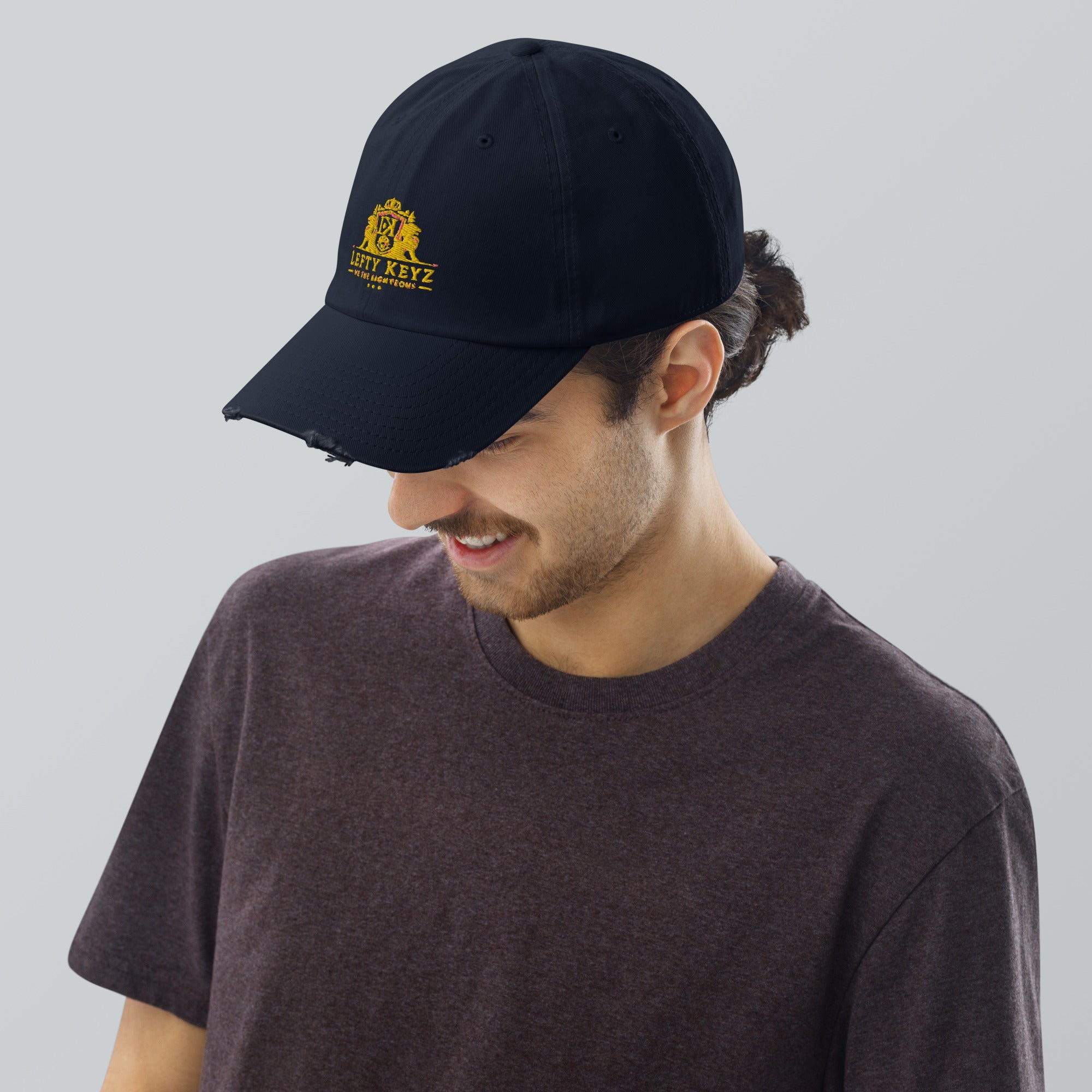 Lefty Keyz Distressed Dad Hat: Man Wearing Black Baseball Cap by Main Street Collective - Urban Streetwear Fashion