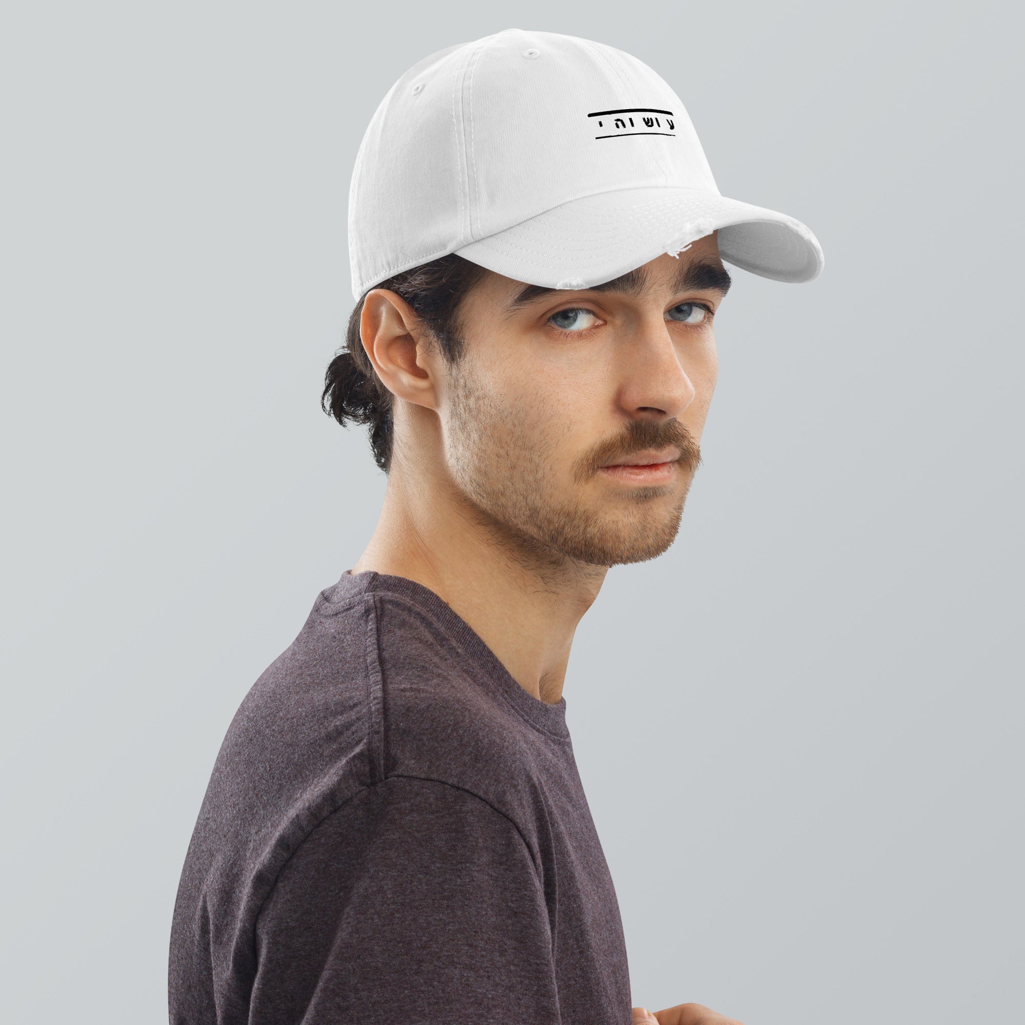 Man in white "ATLANTIS DADE YAHUAH" Hebrew embroidered distressed cap. Main Street Collective.