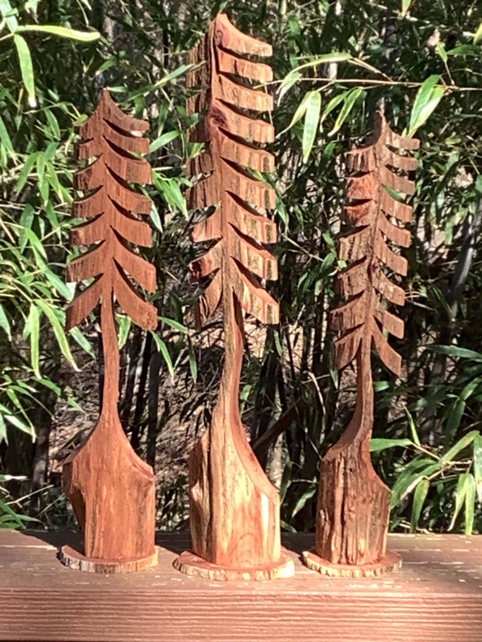 Angled view of three handcrafted miniature cedar trees – rustic decor made in Mississippi by Grayson Unlimited