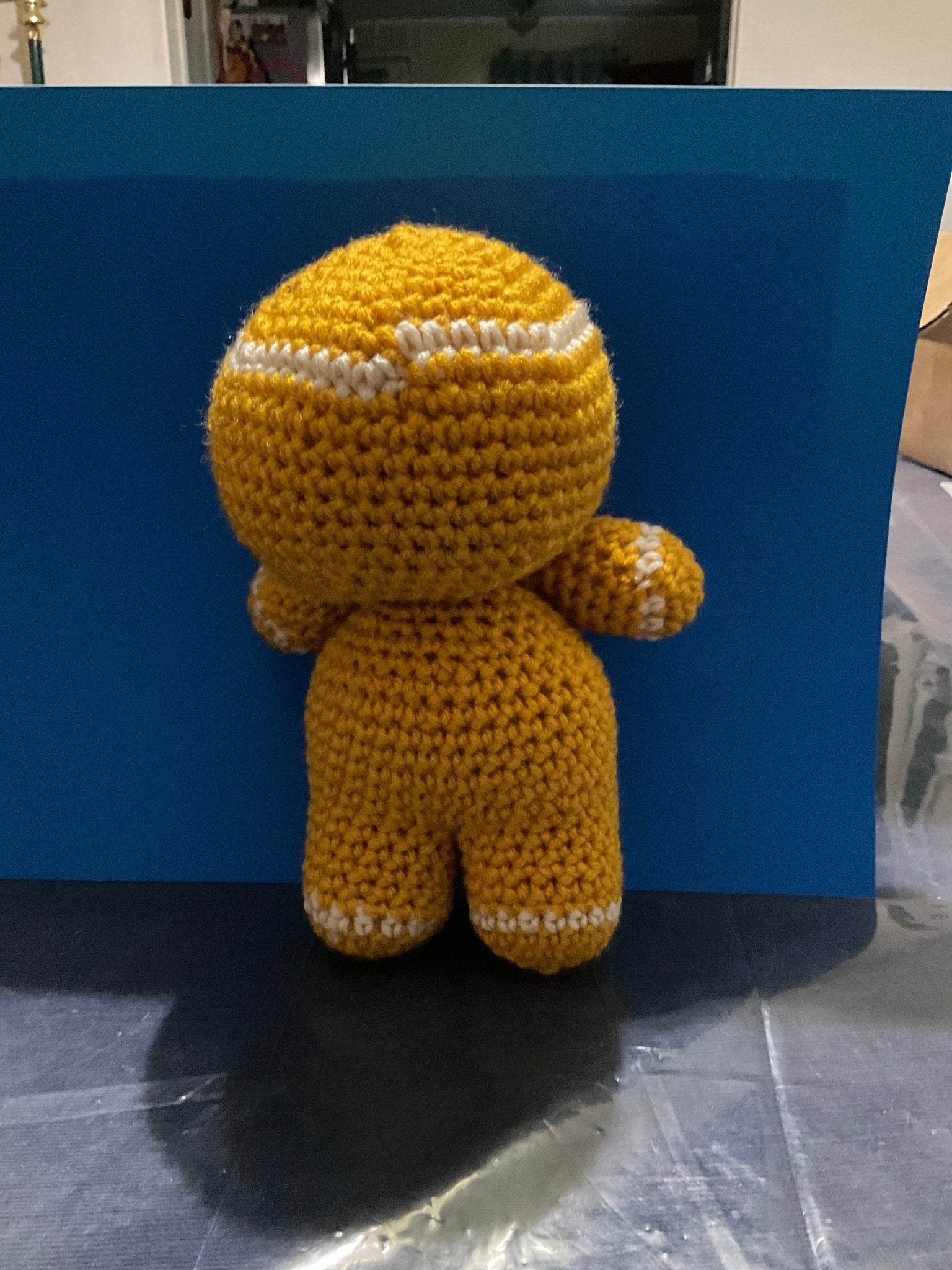 Crocheted Gingerbread Man - 9.5 inch tall, yellow yarn with white accents. Handmade holiday plushie from Main Street Collective.