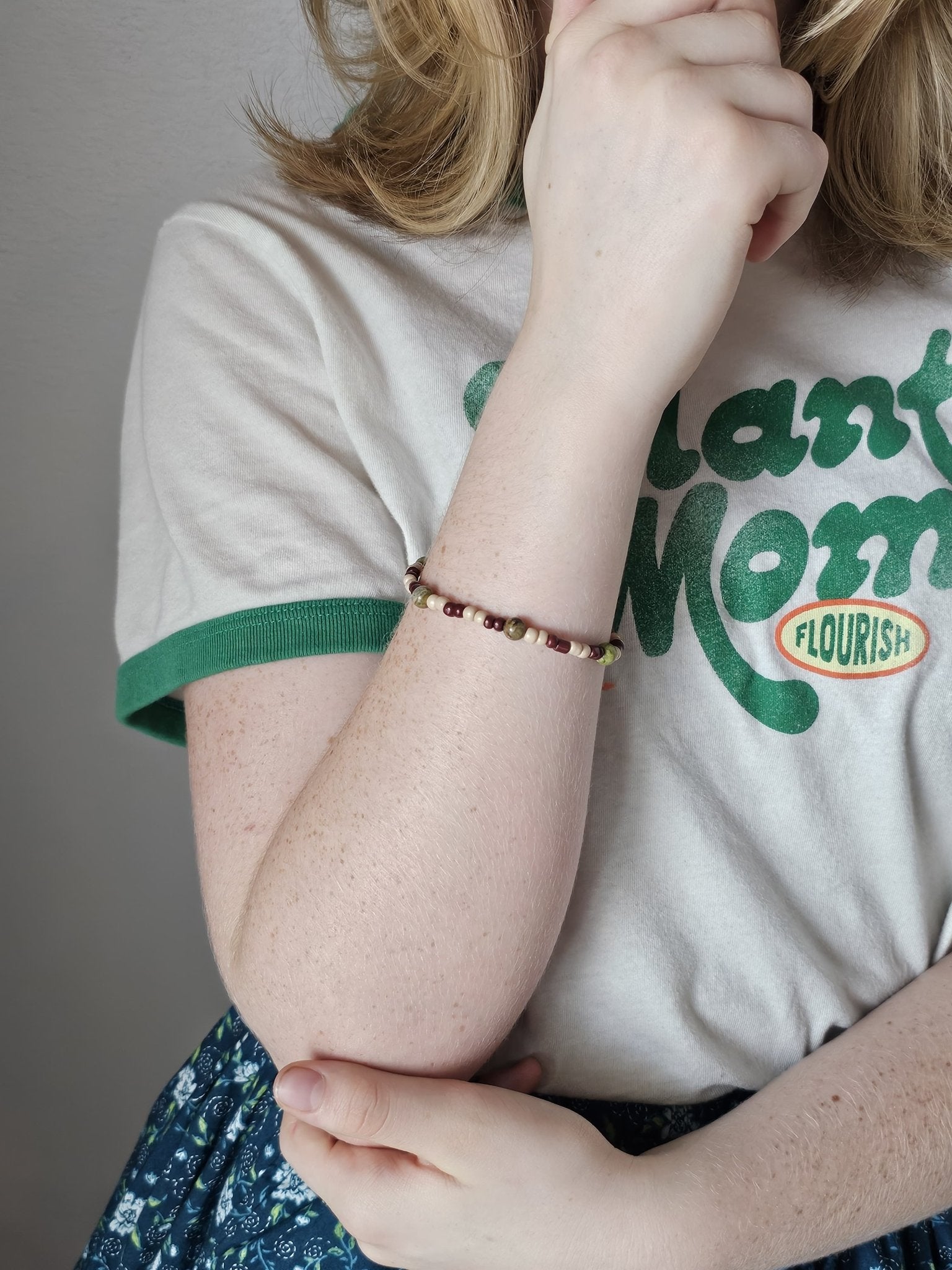WOODLAND EXPLORER BRACELET, handmade beaded stretch bracelet with cream, brown, and green beads by 11-year-old Nora. Main Street Collective