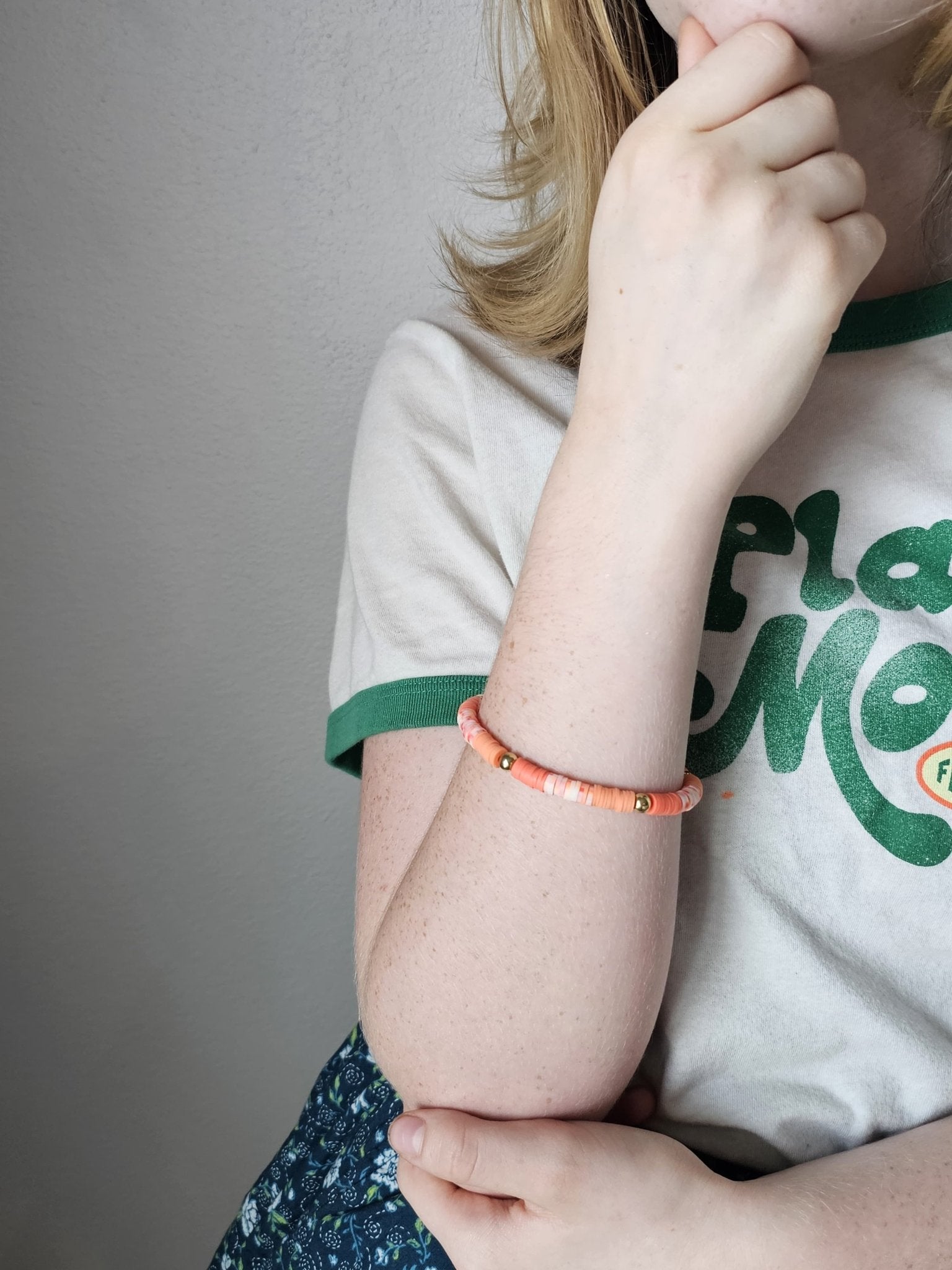 Tween girl wearing orange & peach disc bead bracelet | Main Street Collective | Handmade jewelry by Nora (age 11)