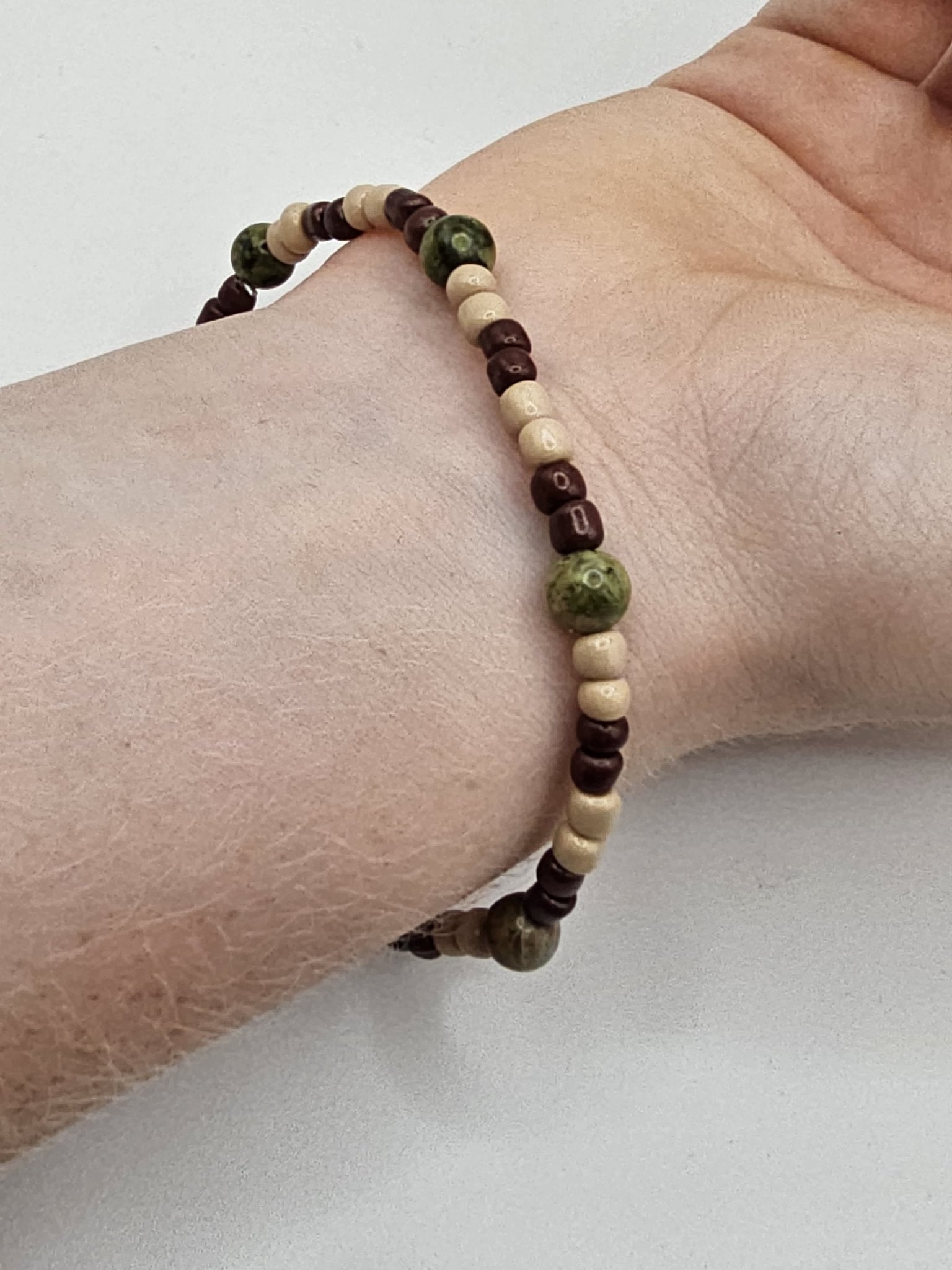 Woodland Explorer Bracelet - Handmade by Main Street Collective: Cream, Brown, and Green Beaded Bracelet on Wrist