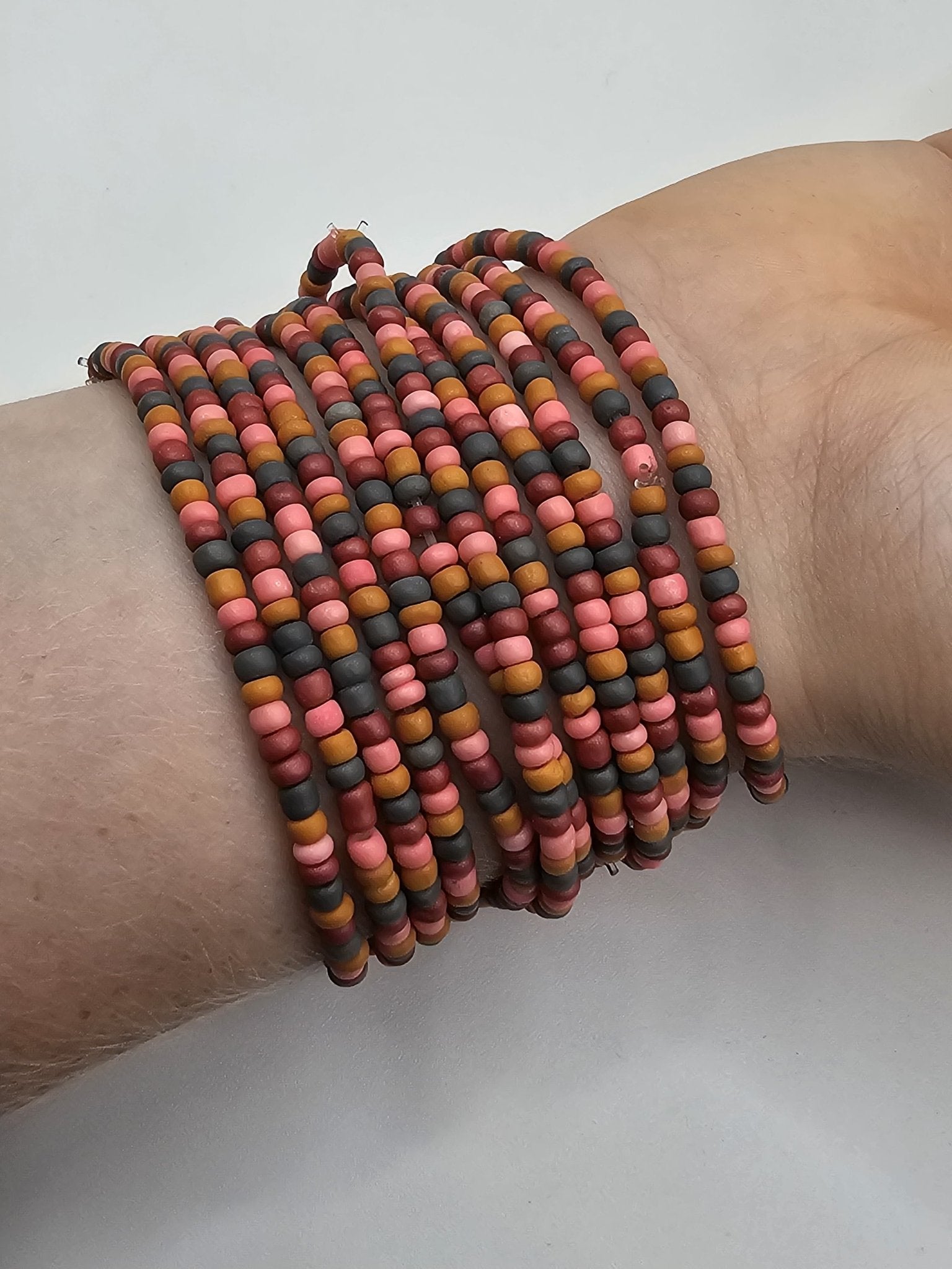 Desert Sunset Beaded Bracelet Stack: Handmade tween fashion by Main Street Collective. Peach, rust, mustard & black beads on wrist.