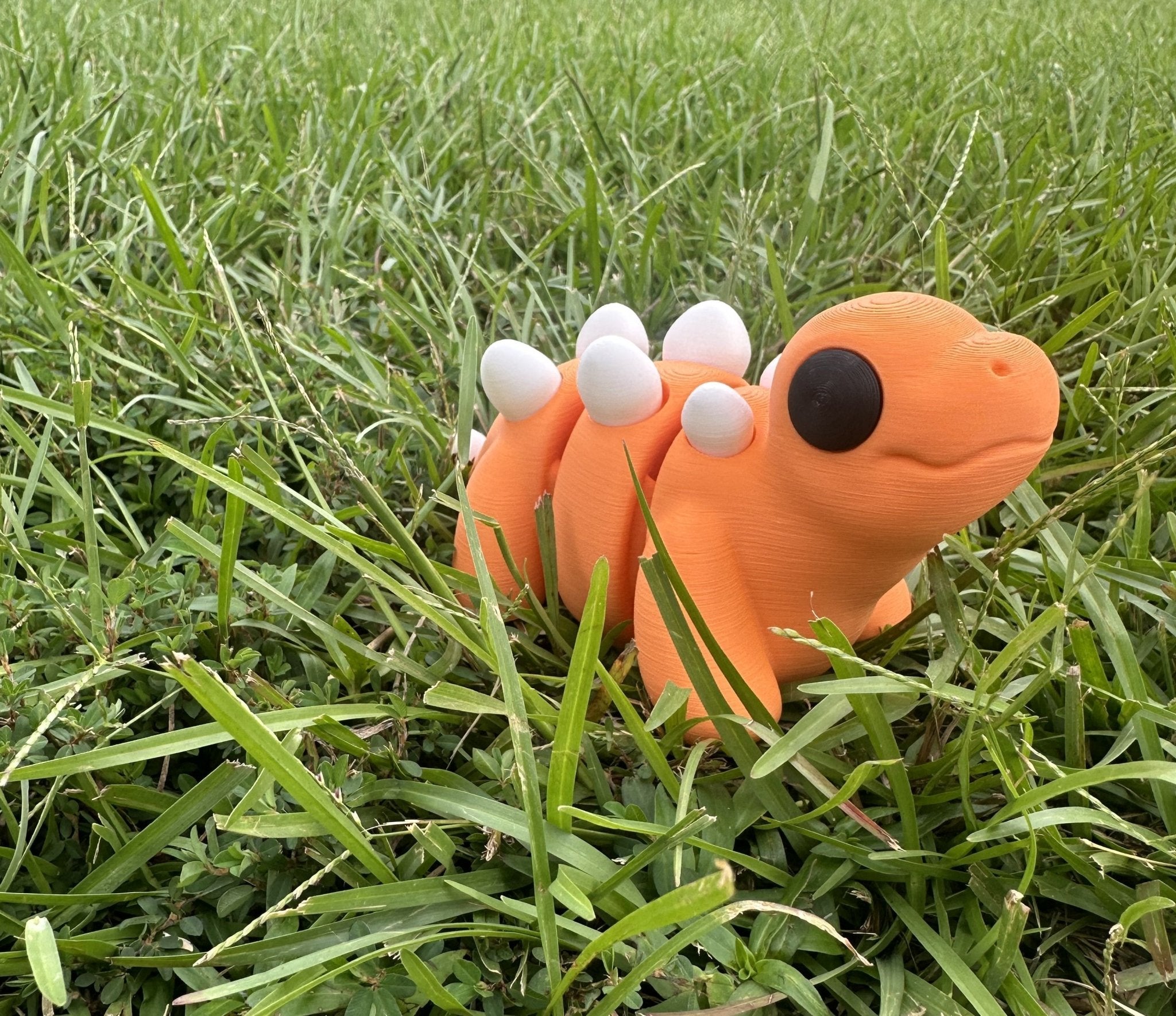 3D Printed Stegosaurus Toy - Orange Fidget Toy handmade by Main Street Collective