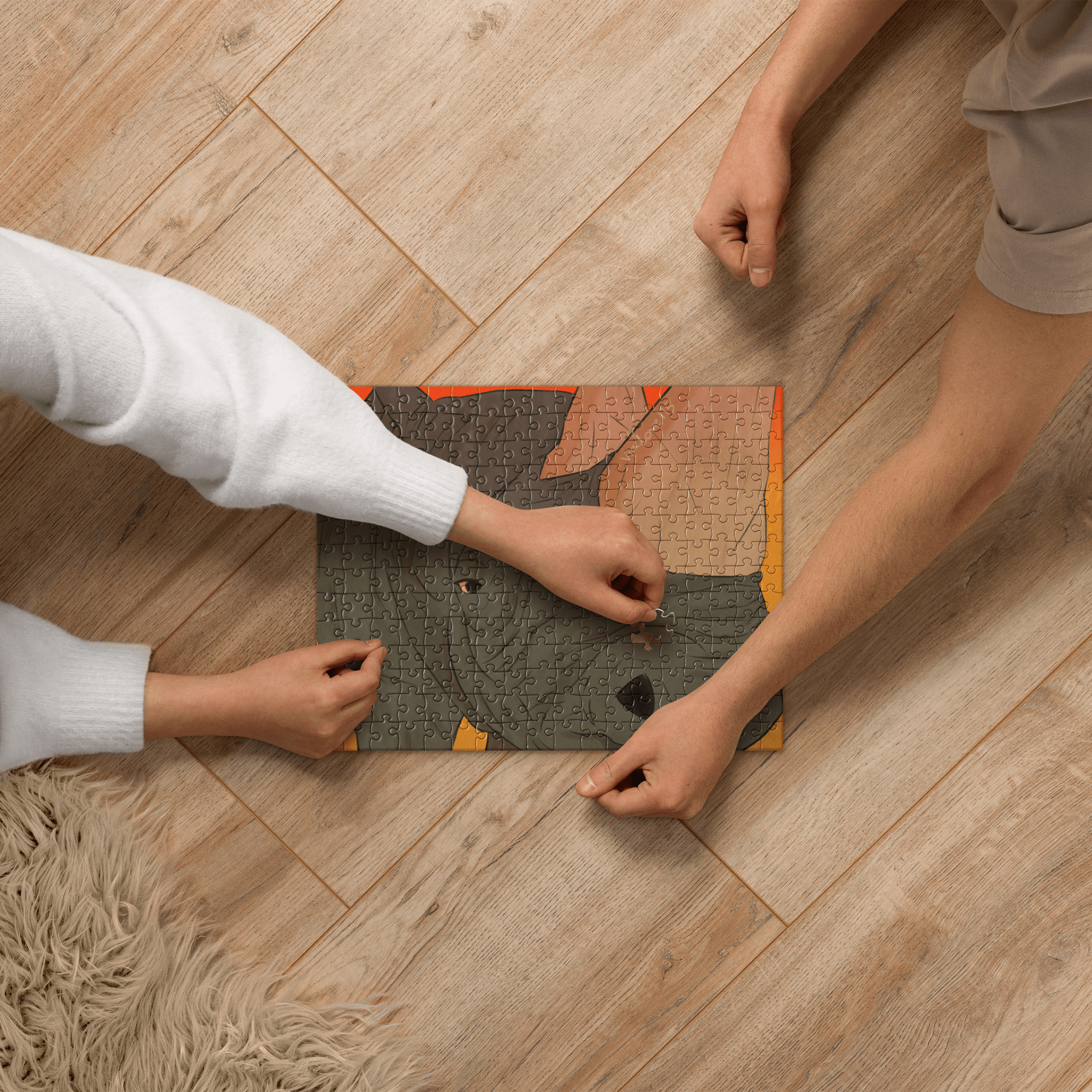 Viola Panther's "Rhino" Jigsaw Puzzle: Two people assembling a 252-piece art puzzle on a wooden floor.