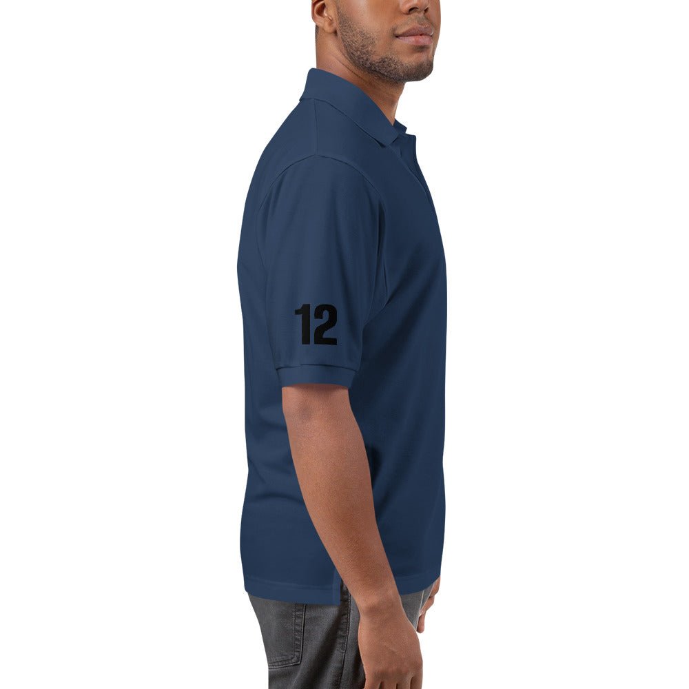 Navy polo shirt with number 12 on sleeve. Men's fashion apparel.