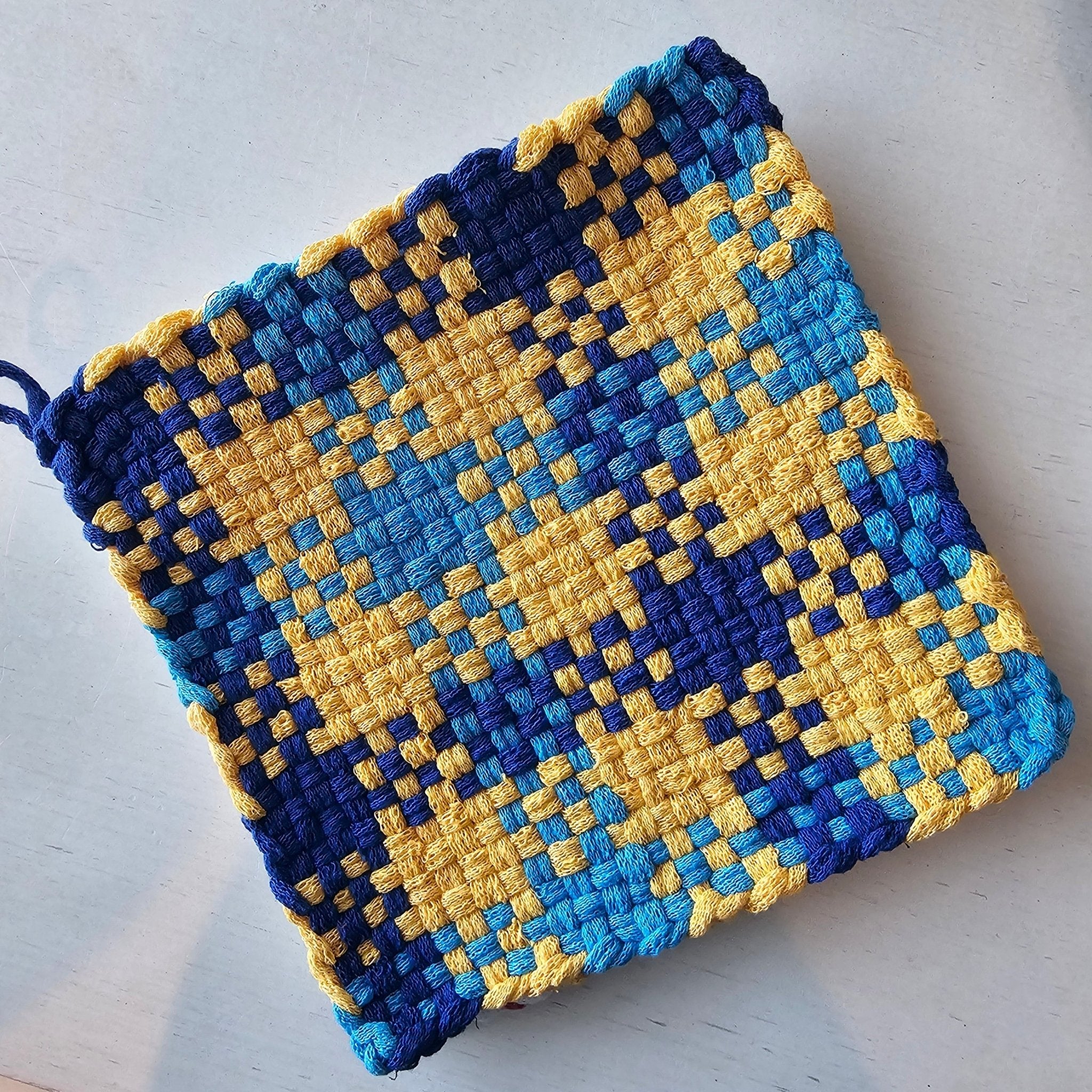 Handmade woven potholder, blue and yellow checkered design, kitchen accessory, Main Street Collective.