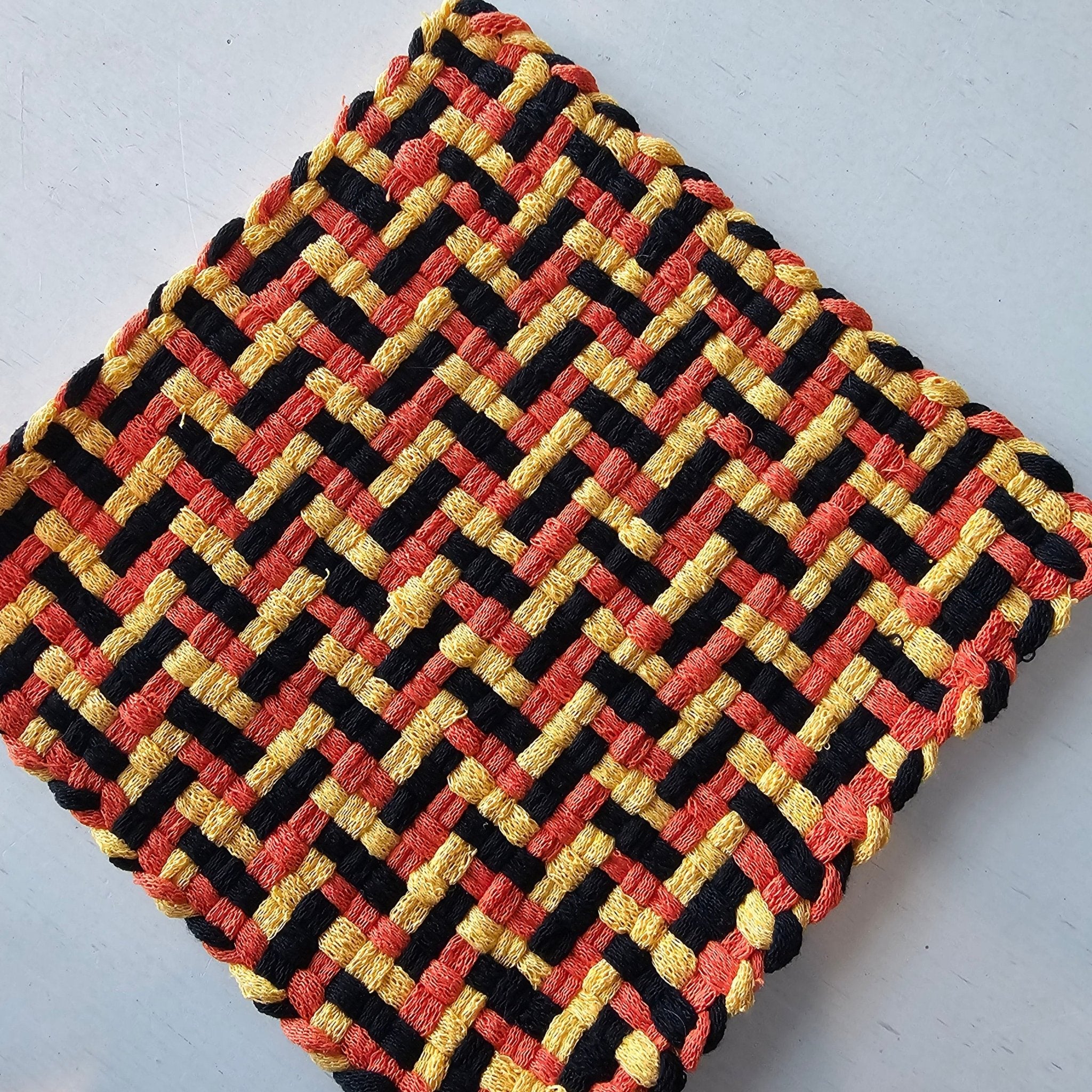 Handmade Woven Potholder: Penelope's Design - Black, Orange, and Yellow - Main Street Collective