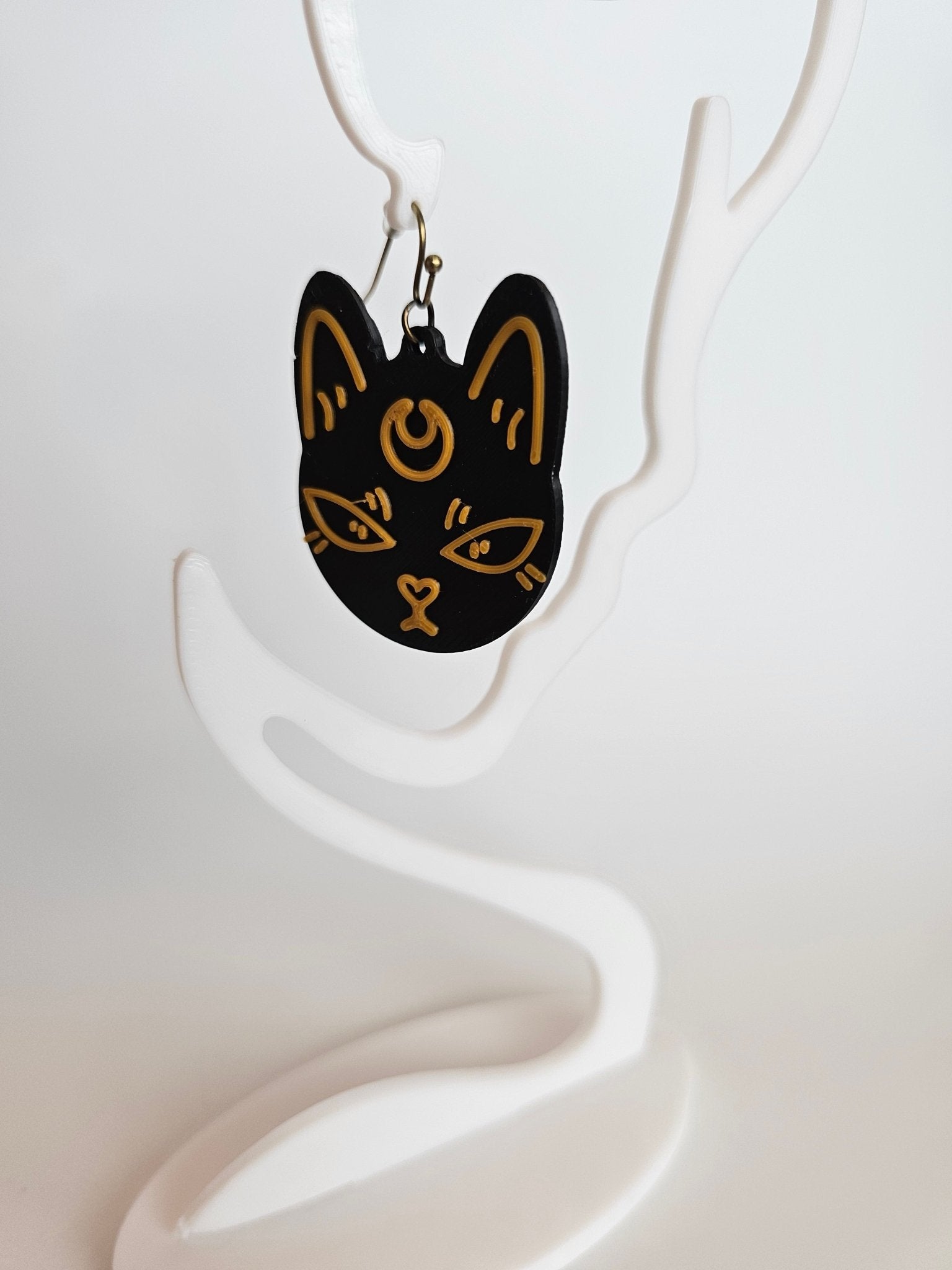 Mystic Moon Cat Earrings: Handmade black & orange cat earrings by The Tween Space. Celestial design, hypoallergenic hooks, Main Street Collective.