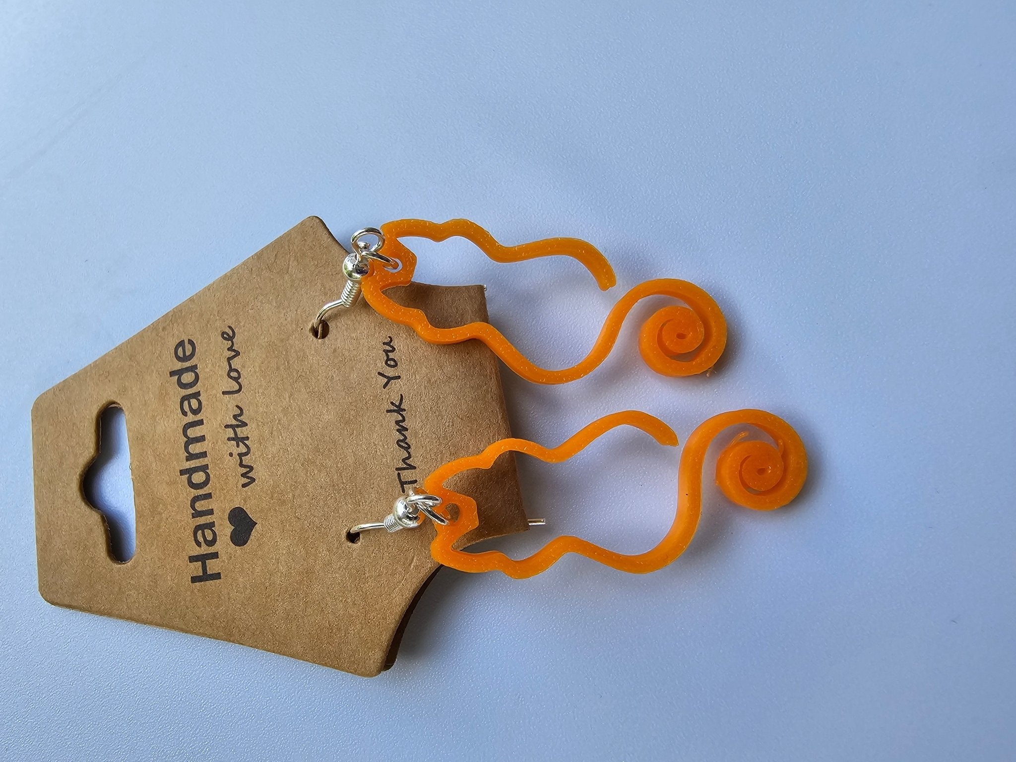 Orange Curly Tail Cat Earrings Handmade by Nora at Main Street Collective: Lightweight, Hypoallergenic, Unique Artisan Jewelry