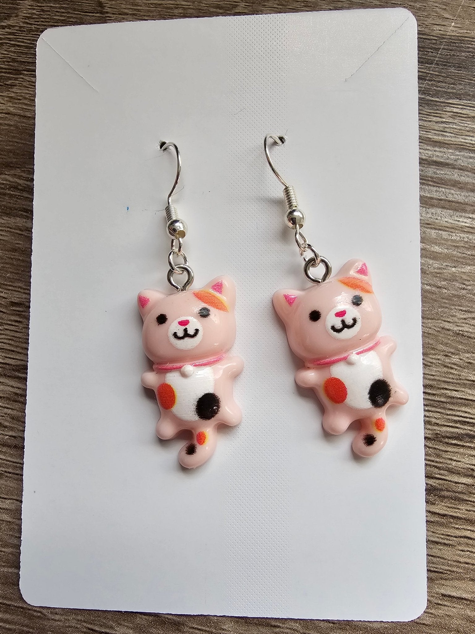 Kawaii Kitty Earrings: Handmade blush-pink calico cat earrings. Cute and playful cat dangle earrings for kids and cat lovers. Main Street Collective