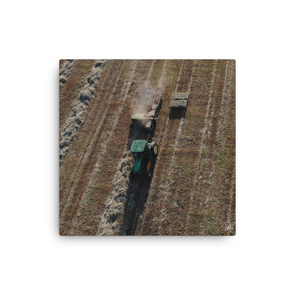 Tractor Making Hay Bales in Farm Field - Aerial View. Green tractor in action, open field landscape.