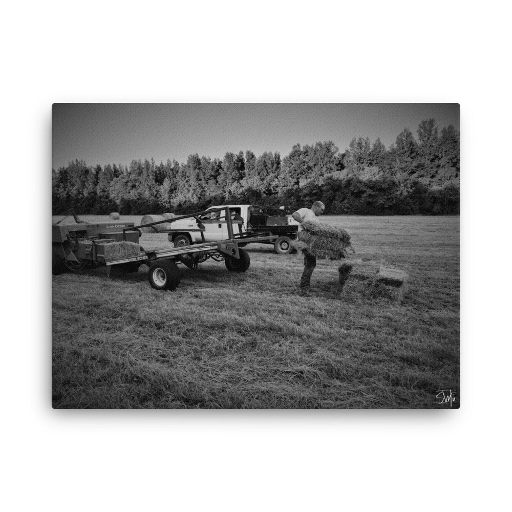 Grayscale farm canvas: Man stacking hay bales near tractor. Rustic art.