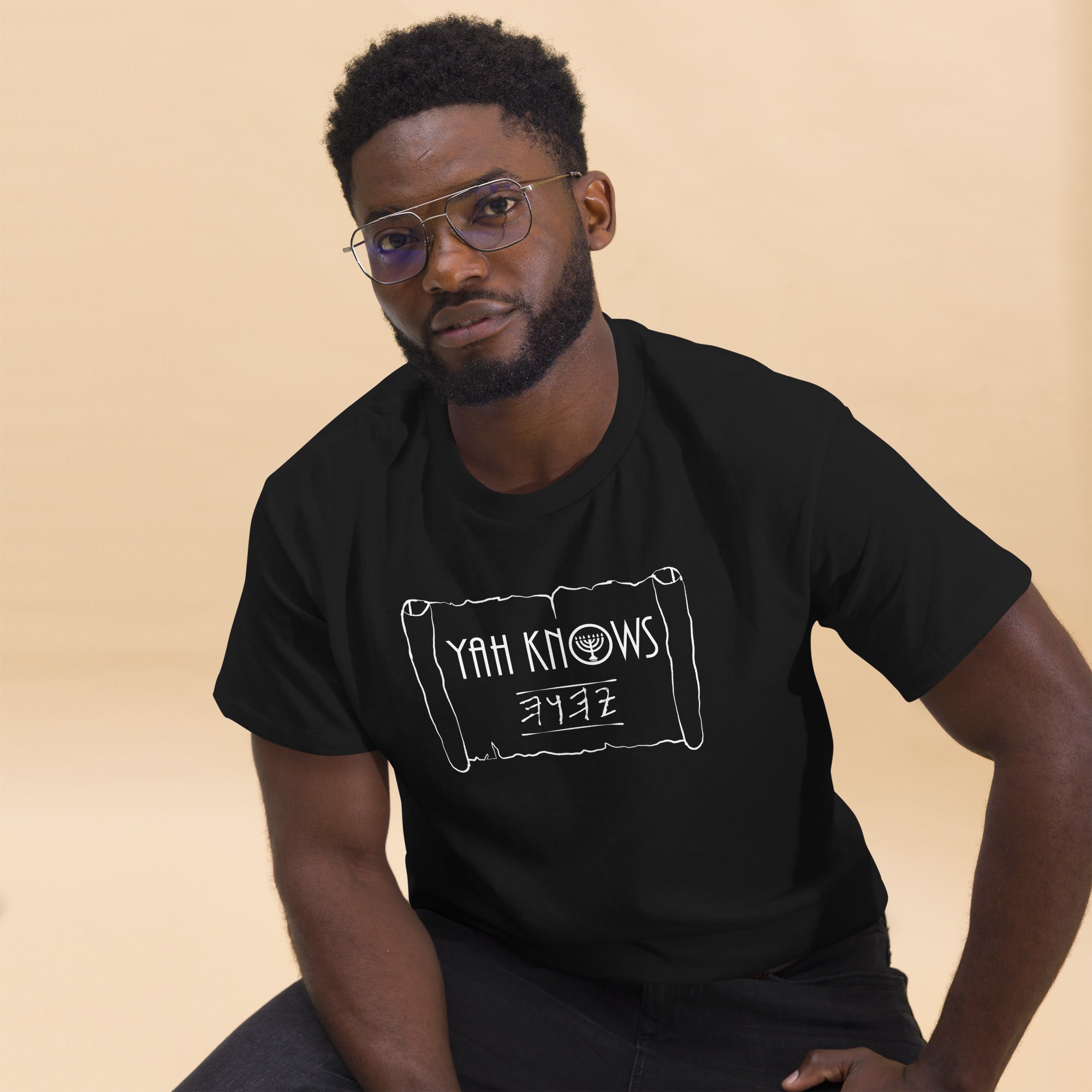Man wearing a black 'YAH Knows' T-shirt with a menorah and paleo Hebrew text. LeftyKeyz limited edition.