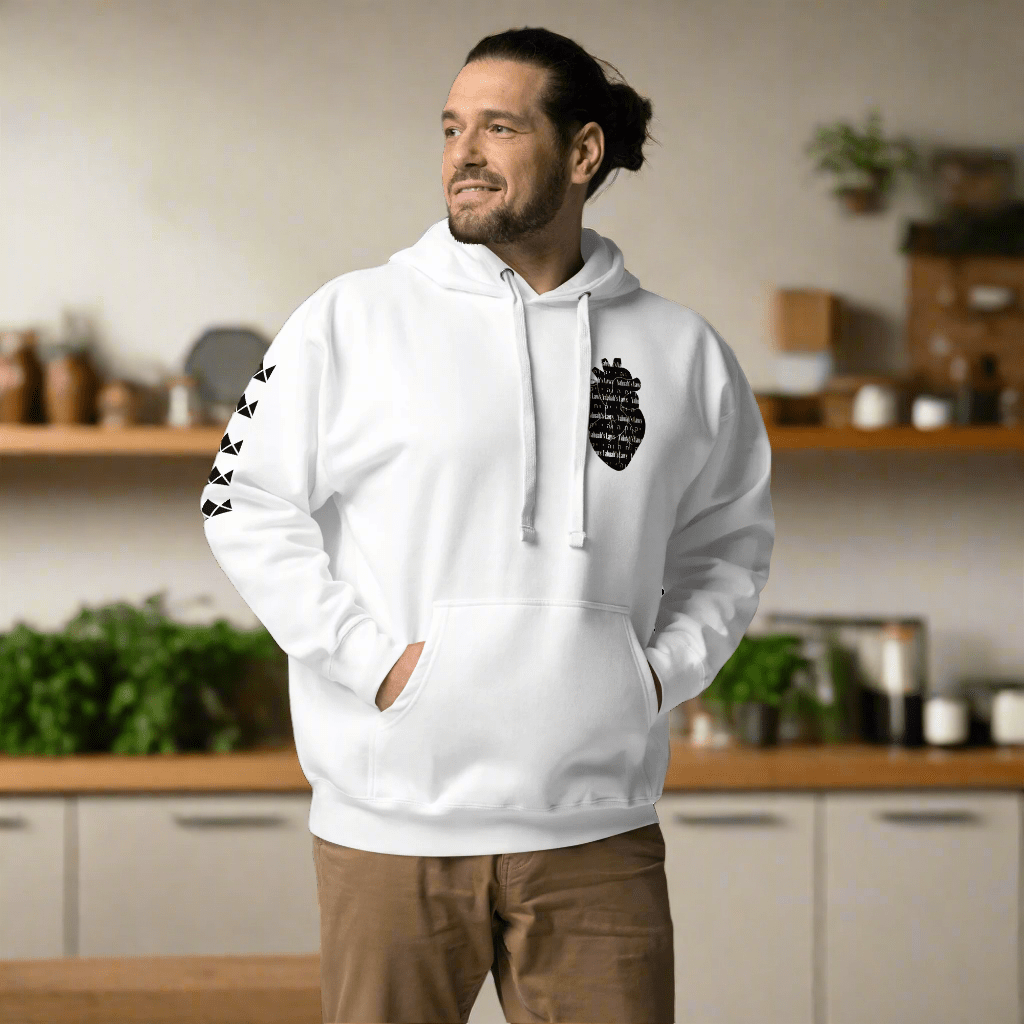 Man in "YAHUAH'S LAWS" Hoodie: White pullover with religious design, sleeve print, & anatomical heart emblem. Stylish & comfortable.