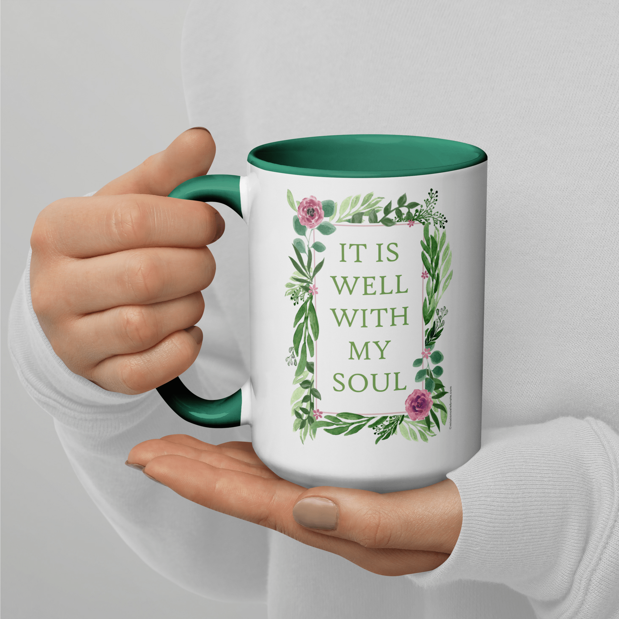 It Is Well With My Soul Floral Ceramic Mug with Green Handle, held in hands. Inspirational quote design on mug.